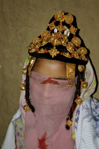 Bride veiled by her clothes and wraped in a sheet to protect her 